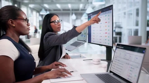 Two Women Using Laptop To Manage E-procurement Stock Footage 334924386