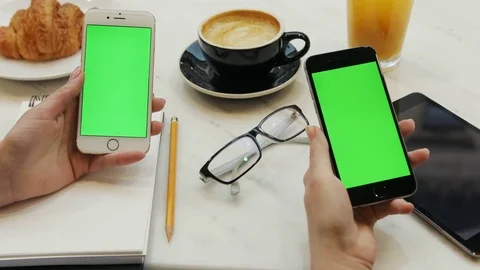 Two women using smartphone with green screen. Close-up video of two women hands Stock Footage 72362010