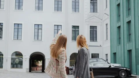 Two women view the building, the windows in the building and make a decision. Stock Footage 112885643