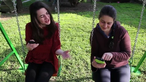 Two Women Viewing Content On A Mobile Phone Stock Footage 73963636