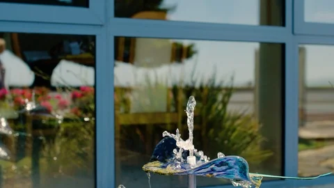 Two women walking out-of-focus by a water feature Stock Footage 87837951