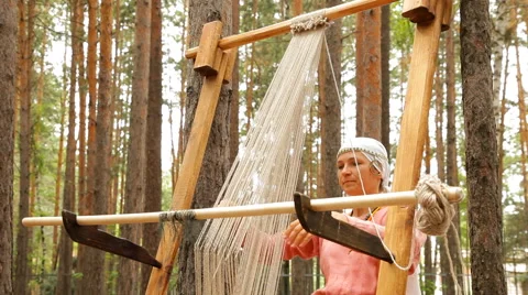 Two women weaving cloth using a traditional ancient machine Stock Footage 62473795