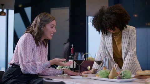 Two women while drinking at a dinner party in a penthouse apartment Stock Footage 293512772