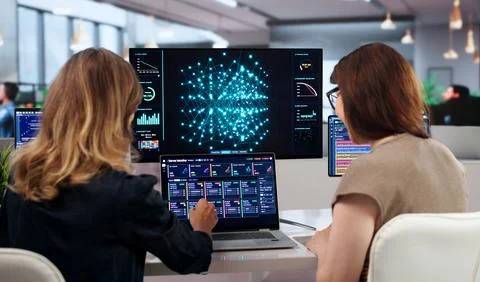 Two Women Working On AI Software Development Using Laptops And Teamwork. Stock Photos