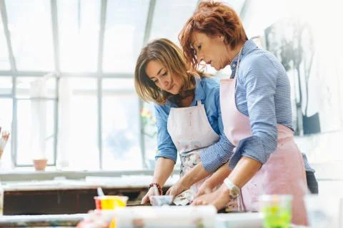 Two women working in creative studio Stock Photos