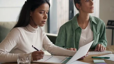 Two women working at home in notes and on computer Stock-Footage 231758271