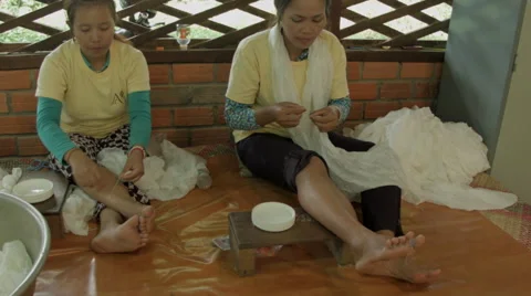 Two women working with silk thread in Siem Reap Cambodia Stock-Footage 48012799