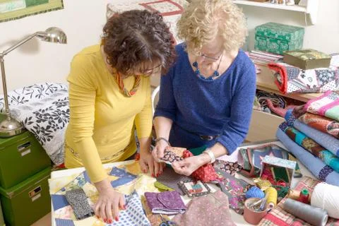Two women working on their patchwork Stock Photos