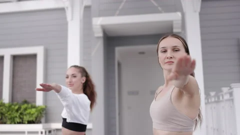 Two women workout and take a yoga class on the ground of house. Yoga teacher Stock Footage 148422509