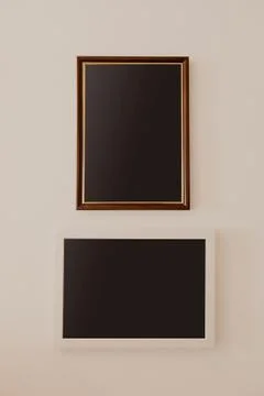 Two wooden frames hanging on wall - Image Stock Photos