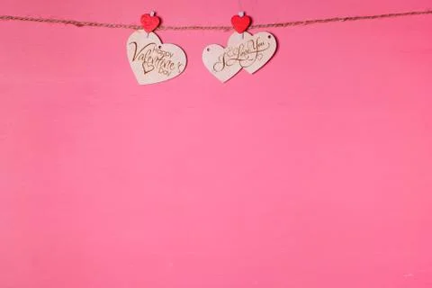 Two wooden hearts on a string Two red hearts on a clothespin on View from abo Stock Photos