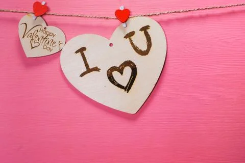 Two wooden hearts on a string Two red hearts on a clothespin on View from abo Fotos Stock