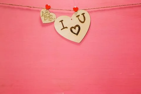 Two wooden hearts on a string Two red hearts on a clothespin on View from abo Stock Photos