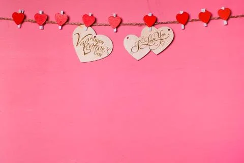 Two wooden hearts on a string Two red hearts on a clothespin on. View from ab Stock Photos