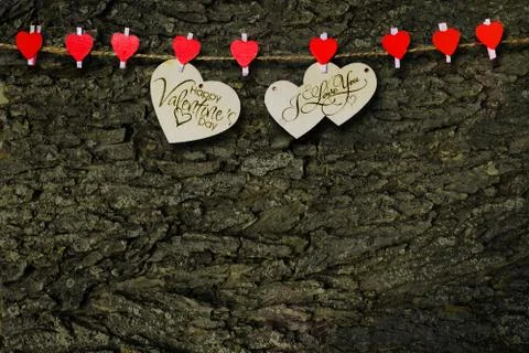 Two wooden hearts on a string Two red hearts on a clothespin on. View from ab Foto stock