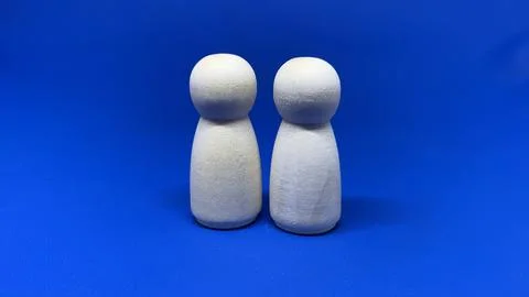 Two wooden peg figures standing side by side, Stock Photos