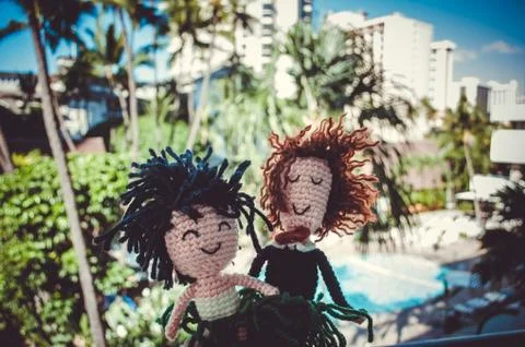 Two wool puppets in front of a typical resort vew in Honolulu, Hawaii Stock Photos