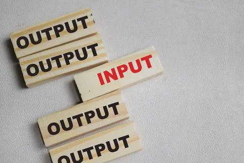 Two words input or output. Choose input on stacked wooden cubes Stock Photos