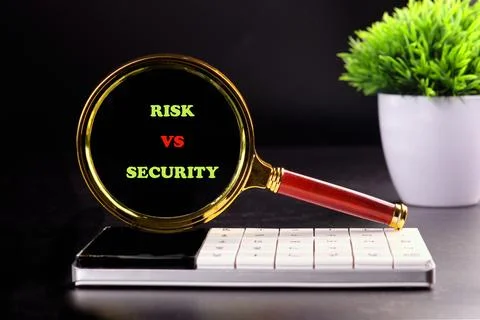 Two words risk and security are displayed in green and red on a black backgro Photos