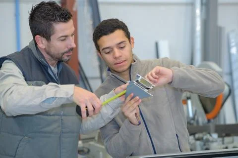Two worker in factory on the machine Stock Photos