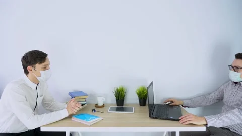 Two worker men wearing protective medical face masks, communication concept  Stock Footage 131470431