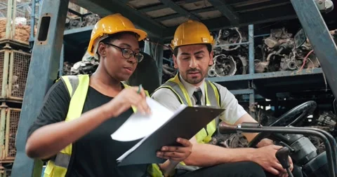 Two worker technical in forklift car discuss together on process in factory Stock Footage 156385008