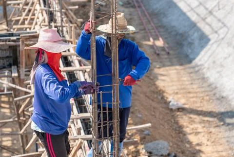 Two worker wire bundle steel rod for concrete pole. Stock Photos