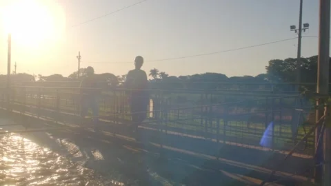 Two workers about to perform regular water sample check in cotton factory Stock Footage 248038670