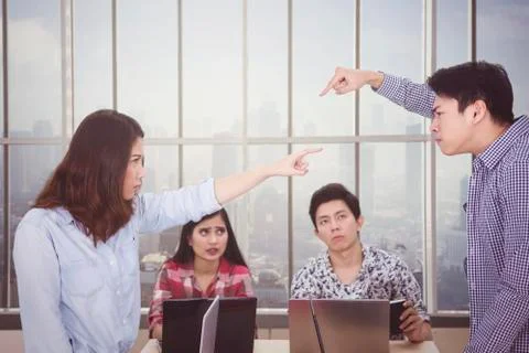 Two workers accusing each other in team meeting Stock Photos