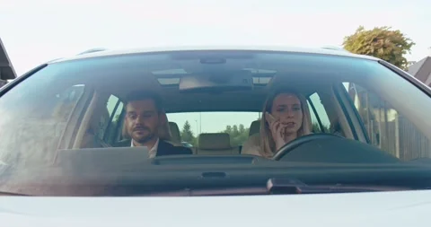 Two workers are driving in the car. Businesswoman is driving a car, businessman Stock Footage 157357885