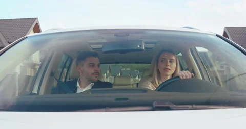 Two workers are driving in the car. Businesswoman and businessman are talking to Stock Footage 157358111