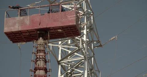 Two workers are servicing an electric tower on a crane Stock Footage 146814743