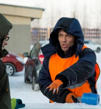 Two workers at the assembly site of the ice town Stock-Fotos