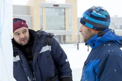 Two workers at the assembly site of the ice town 스톡 사진