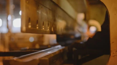 Two workers bending sheet metal with a large production machine machine work Stock Footage 57513395