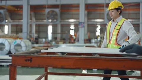 Two workers check quality of metal sheet on plant at manufacturing metal factory Видео 240382645