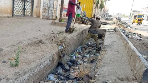 Two Workers Clearing Drainage With Shovel And Digger Kano Nigeria 動画素材 331071518