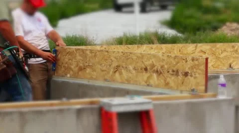 Two workers constructing house on foundations Stock Footage