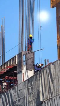 Two workers on the construction site. Stock Photos
