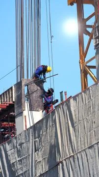 Two workers on the construction site. Stock Photos