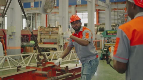 Two workers controlling the heavy-duty crane in the factory Stock Footage 203897127