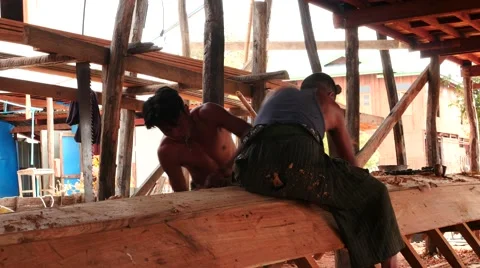 Two workers creating a boat in Myanmar by traditional old methods  Stock Footage 61323499