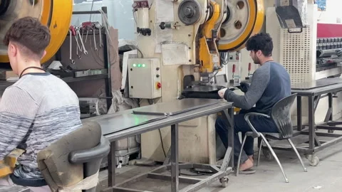 Two workers deeply focused on their machinery tasks Stock Footage 318922180