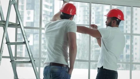 Two workers diligently measuring windows for repairs Stock Footage 311813519