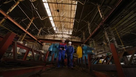 Two workers discuss a construction project Stock Footage 84771734