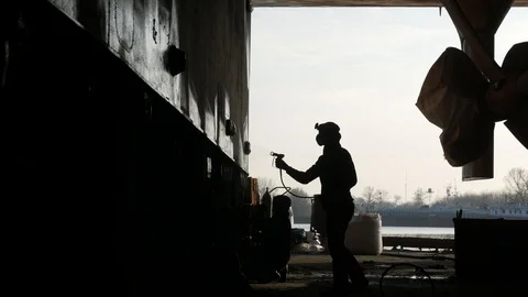 Two workers in the dock paint the ship. Stock Footage 87085547