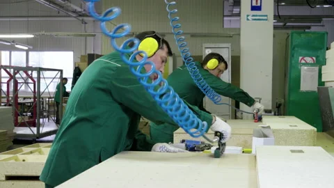 Two workers dressed in uniform make sofa, couch, settee in furniture factory. 4K 動画素材 152045854