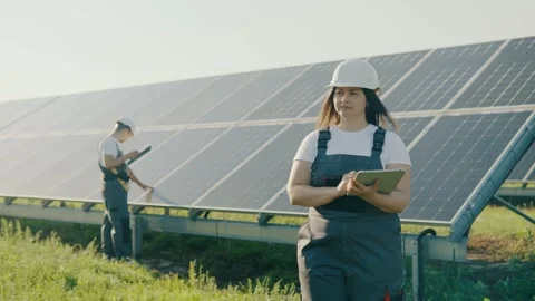 Two workers at an eco-station that processes solar energy collect data Stock Footage 251187773