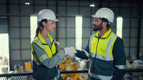 Two workers in a factory greet each other warmly Stock Footage 340984390
