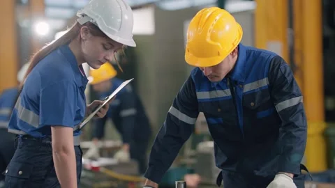 Two workers in a factory setting Stock Footage 341925471